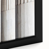 Close-up of a black wall art featuring textured columns in vibrant colors on a framed canvas, ideal for living room decor.