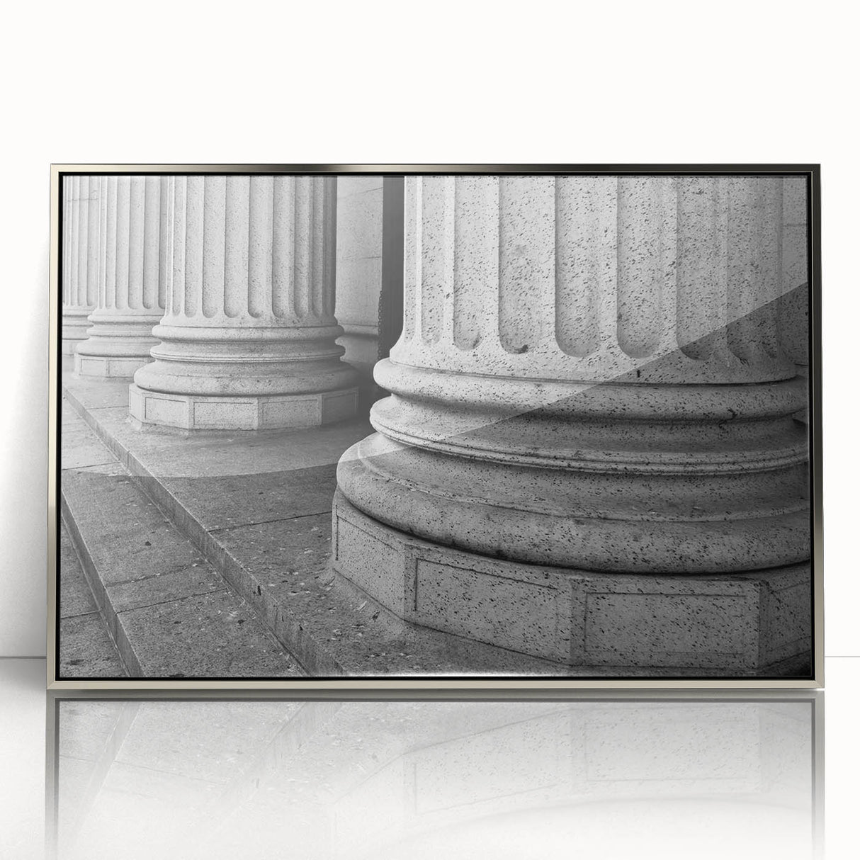 Mid-century modernist art featuring silver-framed acrylic print of architectural columns in muted tones.