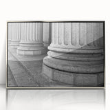 Mid-century modernist art featuring silver-framed acrylic print of architectural columns in muted tones.