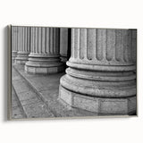 Framed canvas featuring a landscape painting of classical columns in black with colorful accents, ideal for office decor.