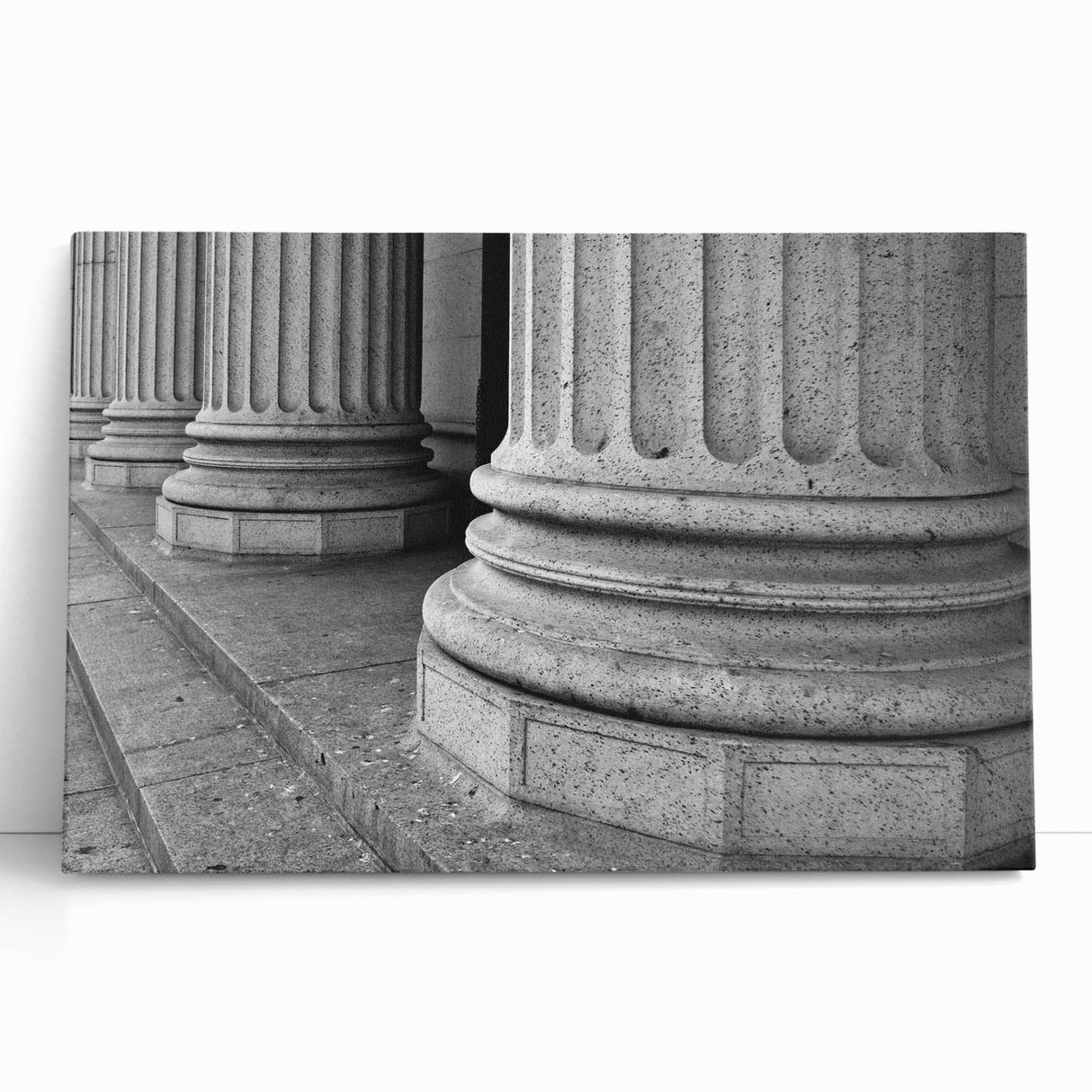 Black and white photo of classical columns printed on large stretched canvas.