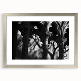 Textured art print featuring abstract columns in gray tones on a framed silver mat, ideal for bedroom decor.