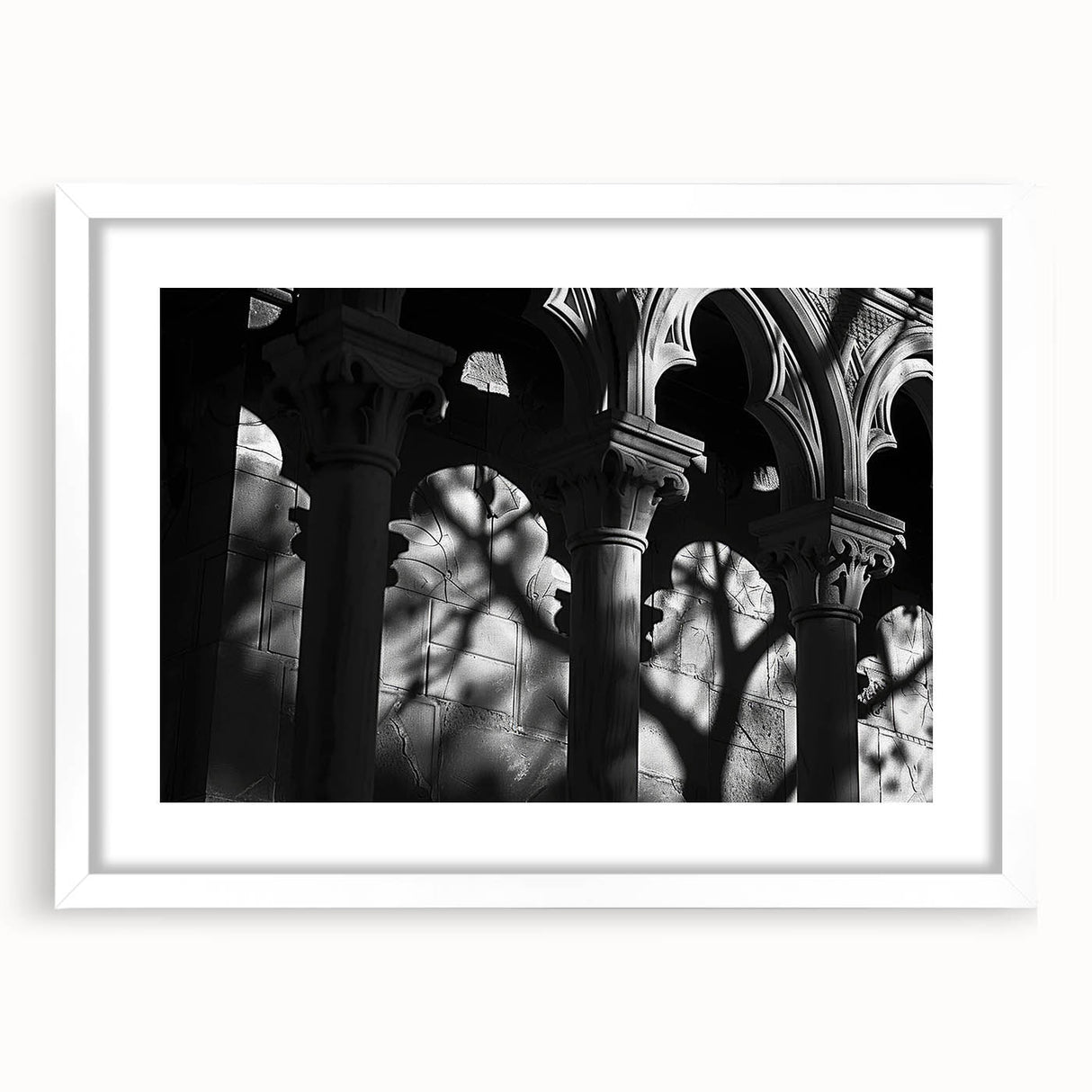 Abstract art print featuring a series of white columns in grayscale, presented in a white mat frame.