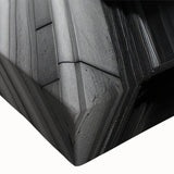 Close-up of a large art piece featuring black and white landscape art paintings of columns, printed on stretched canvas.