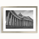 Abstract art print featuring geometric column designs in muted gray, framed in silver, ideal for dining room decor.