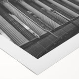 Art deco poster featuring a series of ornate columns in muted beige and white tones on a rolled canvas.