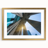 Extra large abstract art print featuring textured columns in muted earth tones, framed in gold, ideal for living room decor.