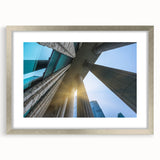 Textured art print of abstract columns in muted gray, framed in silver, ideal for modern bedroom ambiance.