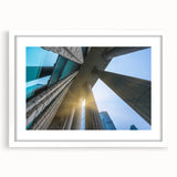 Abstract art print featuring symmetrical column designs in monochrome tones, framed with a white mat.