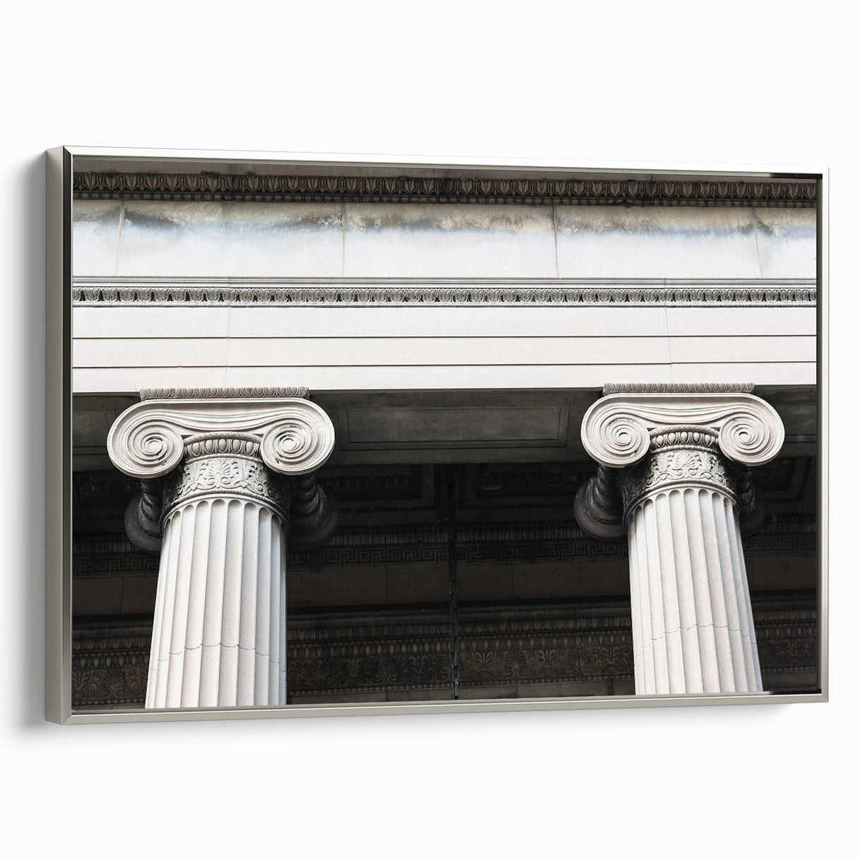 Framed canvas of a vintage poster featuring a black and colorful landscape with architectural columns.