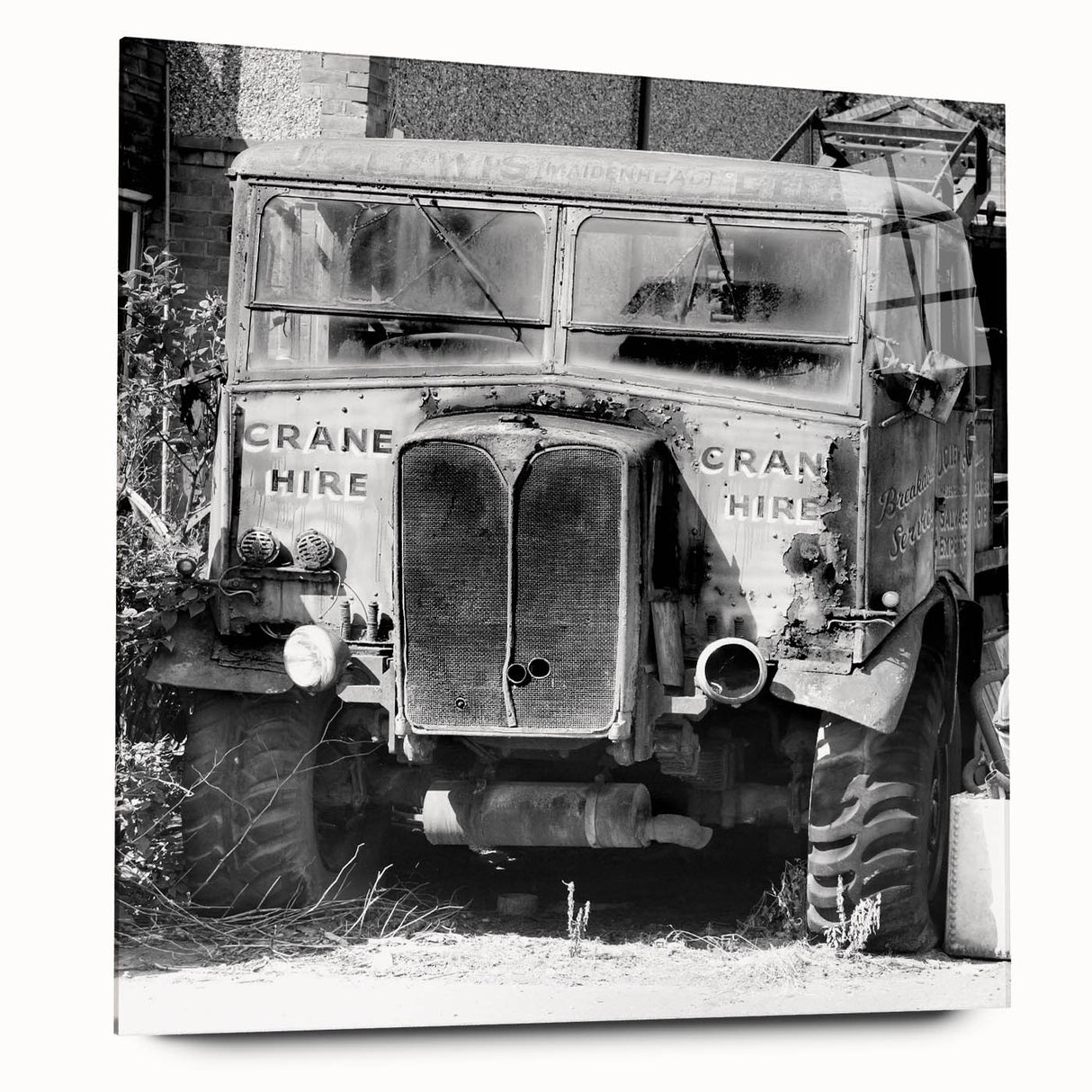 Large abstract wall art on acrylic, featuring a derelict building in muted grays and blues.