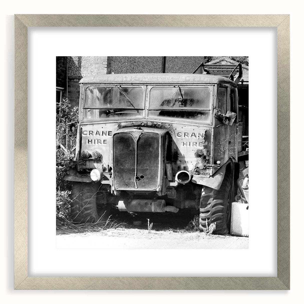 Textured abstract art print in muted gray and tan, displayed in a silver frame, ideal for modern bedroom ambiance.