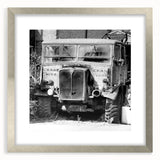 Textured abstract art print in muted gray and tan, displayed in a silver frame, ideal for modern bedroom ambiance.