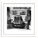 Abstract art print featuring derelict architectural design in muted gray and white tones, framed with a white mat.