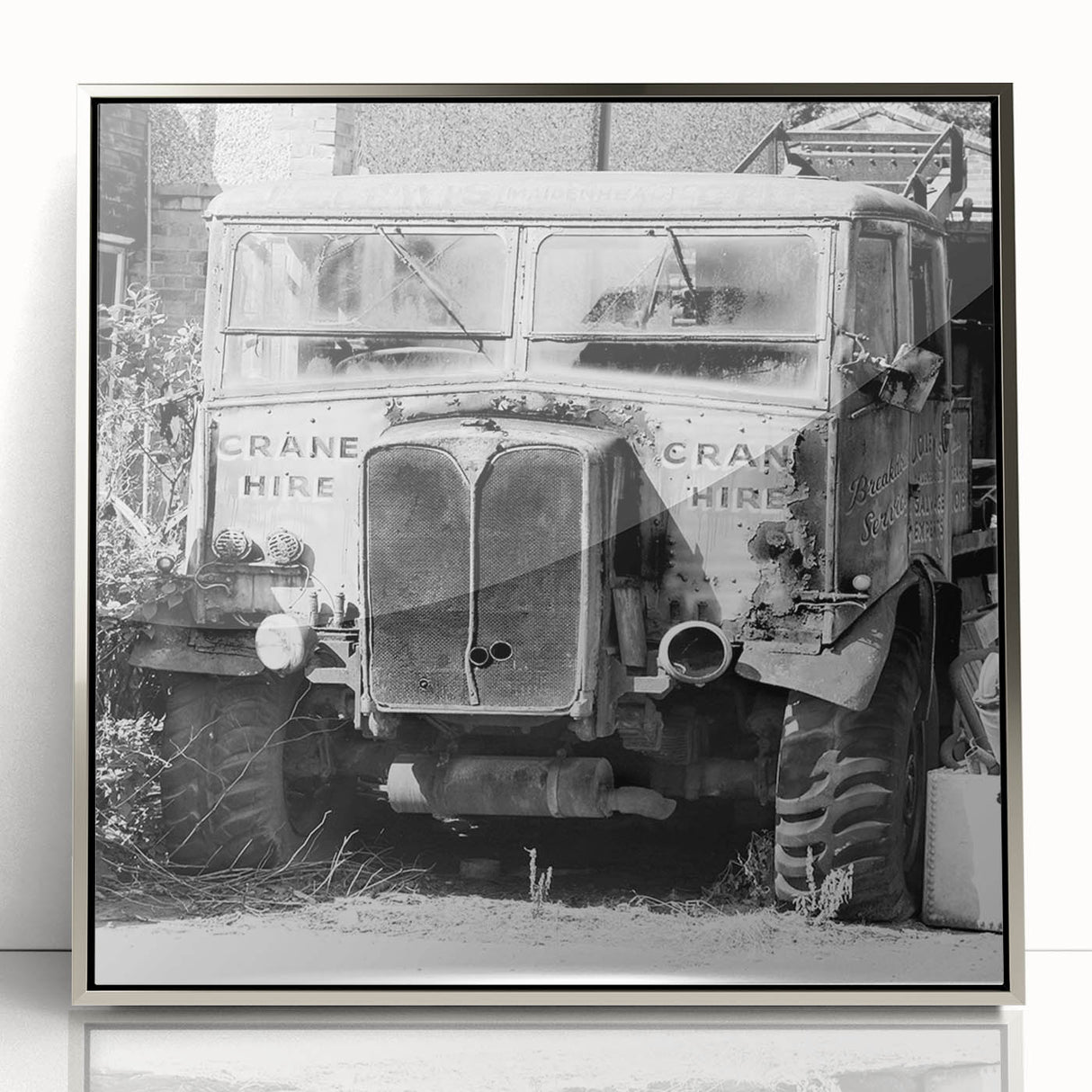 Mid-century modernist art depicting a derelict building, in muted gray and silver tones, acrylic framed poster.