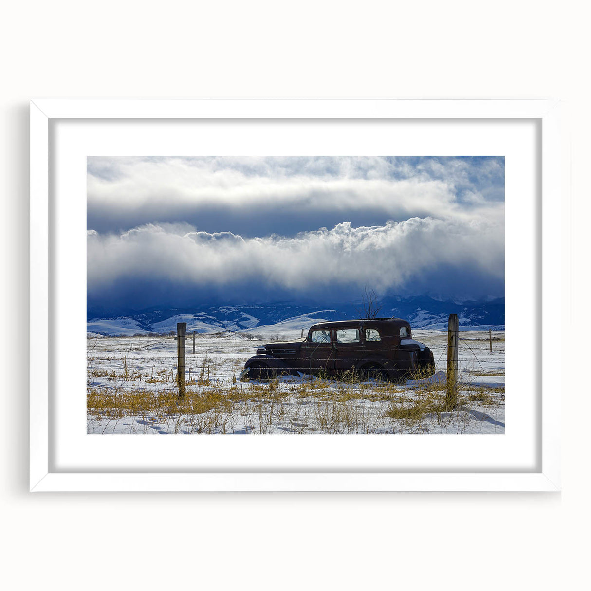 Abstract art print depicting a derelict building in muted gray and blue tones on a white framed canvas.