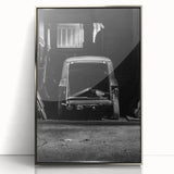 Mid-century modernist art depicting an abstract cityscape in muted gray and blue tones on a silver-framed acrylic print.