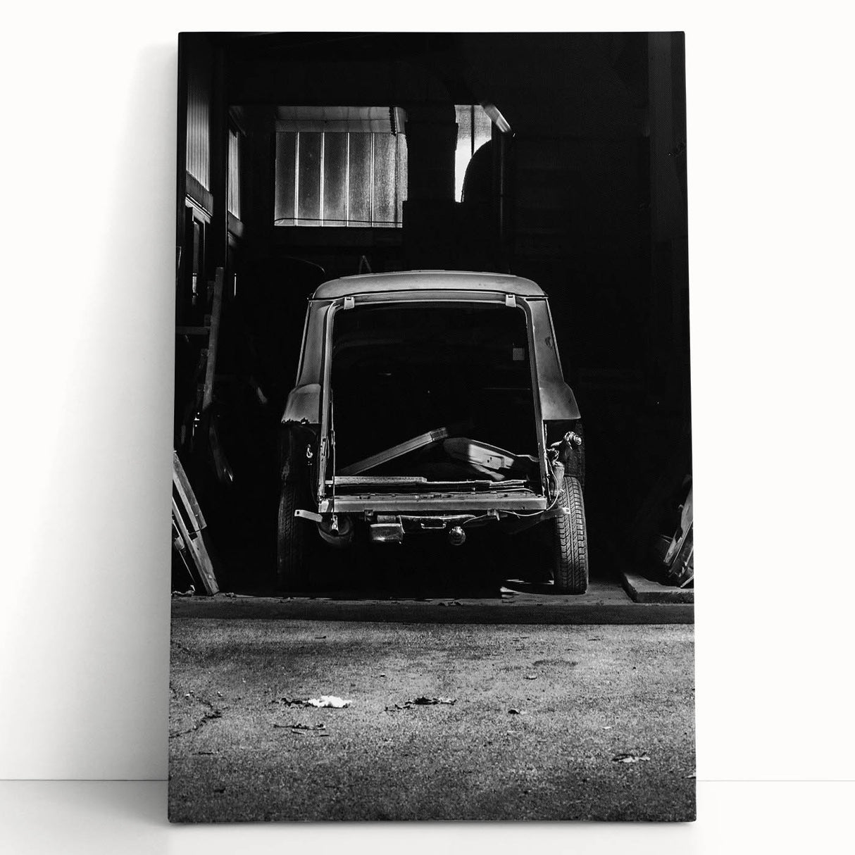 Black and white photograph of a dilapidated building on stretched canvas.