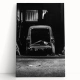 Black and white photograph of a dilapidated building on stretched canvas.