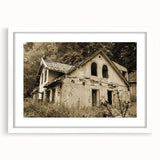 Abstract art print featuring geometric shapes in muted gray and blue tones on a white framed canvas.