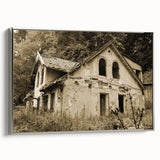 Framed canvas featuring a landscape painting of a dilapidated building in muted earth tones.