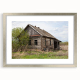 Textured art print featuring abstract, overlapping geometric shapes in muted gray and silver tones, framed with a silver mat.