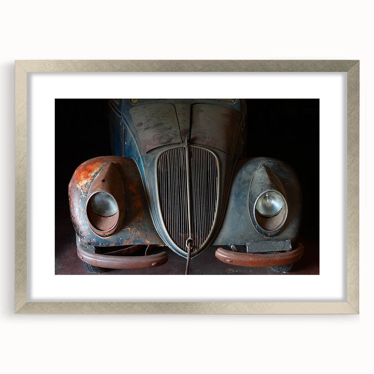 Textured abstract art print depicting a derelict building, rendered in muted grays and blues, framed in silver.