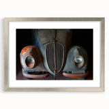 Textured abstract art print depicting a derelict building, rendered in muted grays and blues, framed in silver.