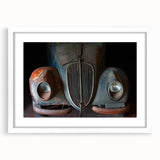 Abstract art print featuring a derelict building in muted gray tones, framed in white, suitable for dining room decor.