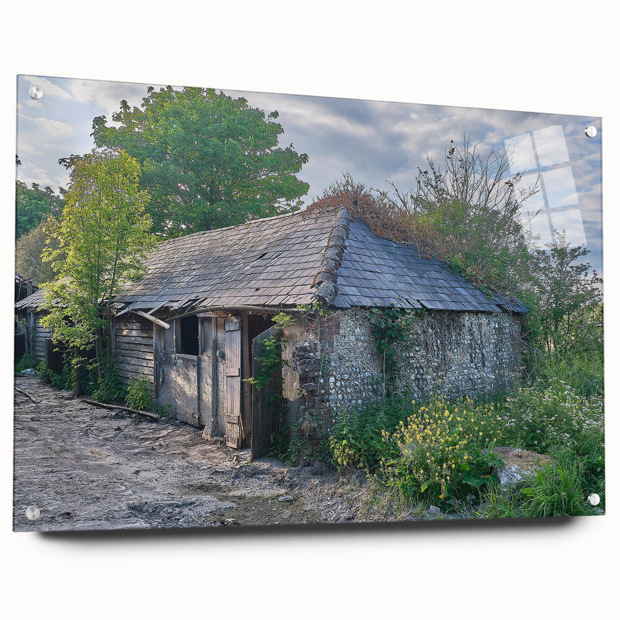 Large abstract wall art on acrylic glass depicting a derelict building, in muted grays and blues.