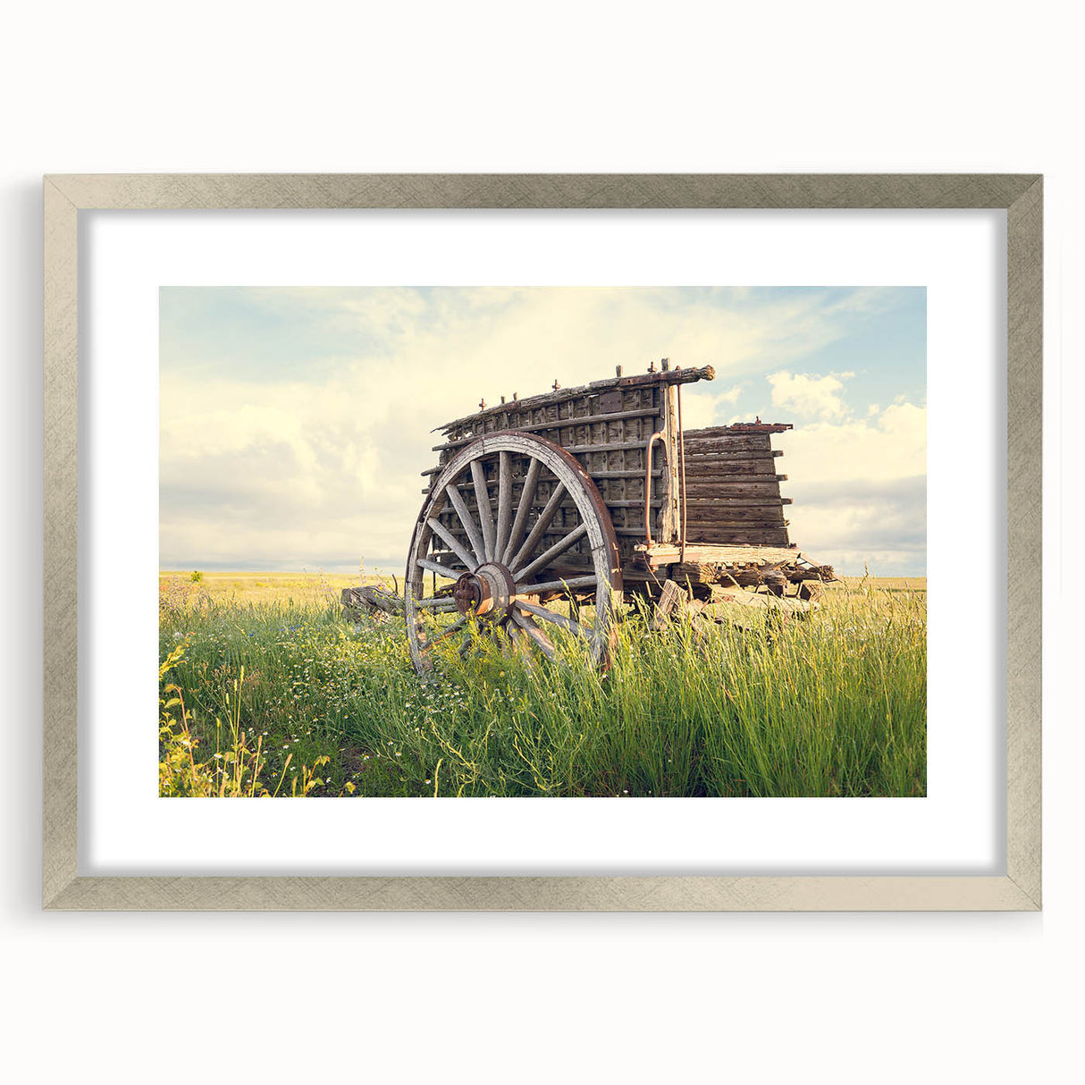 Textured art depicting abstract shapes and lines in muted gray and silver tones, framed with a silver mat.
