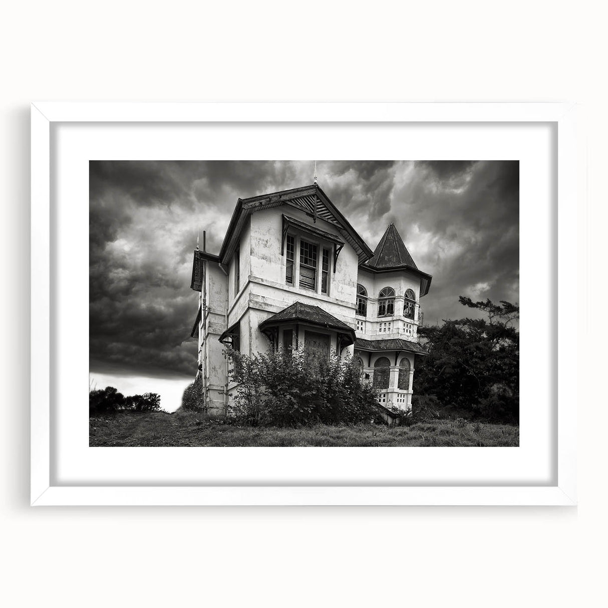 Abstract art print depicting a derelict building in muted gray tones on a white framed poster.
