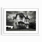 Abstract art print depicting a derelict building in muted gray tones on a white framed poster.