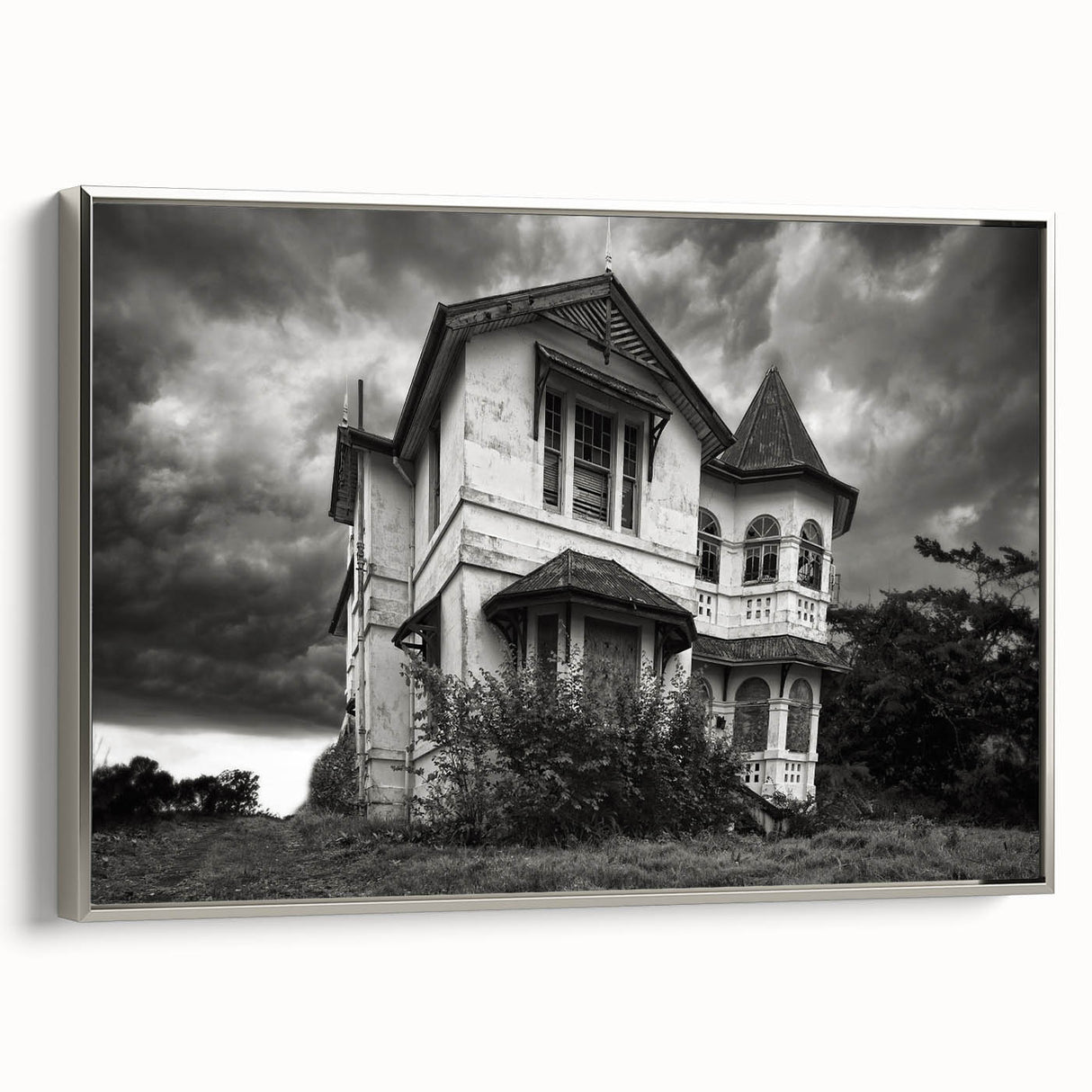 Framed canvas featuring a vintage landscape art painting of a derelict building in muted black and colorful tones.