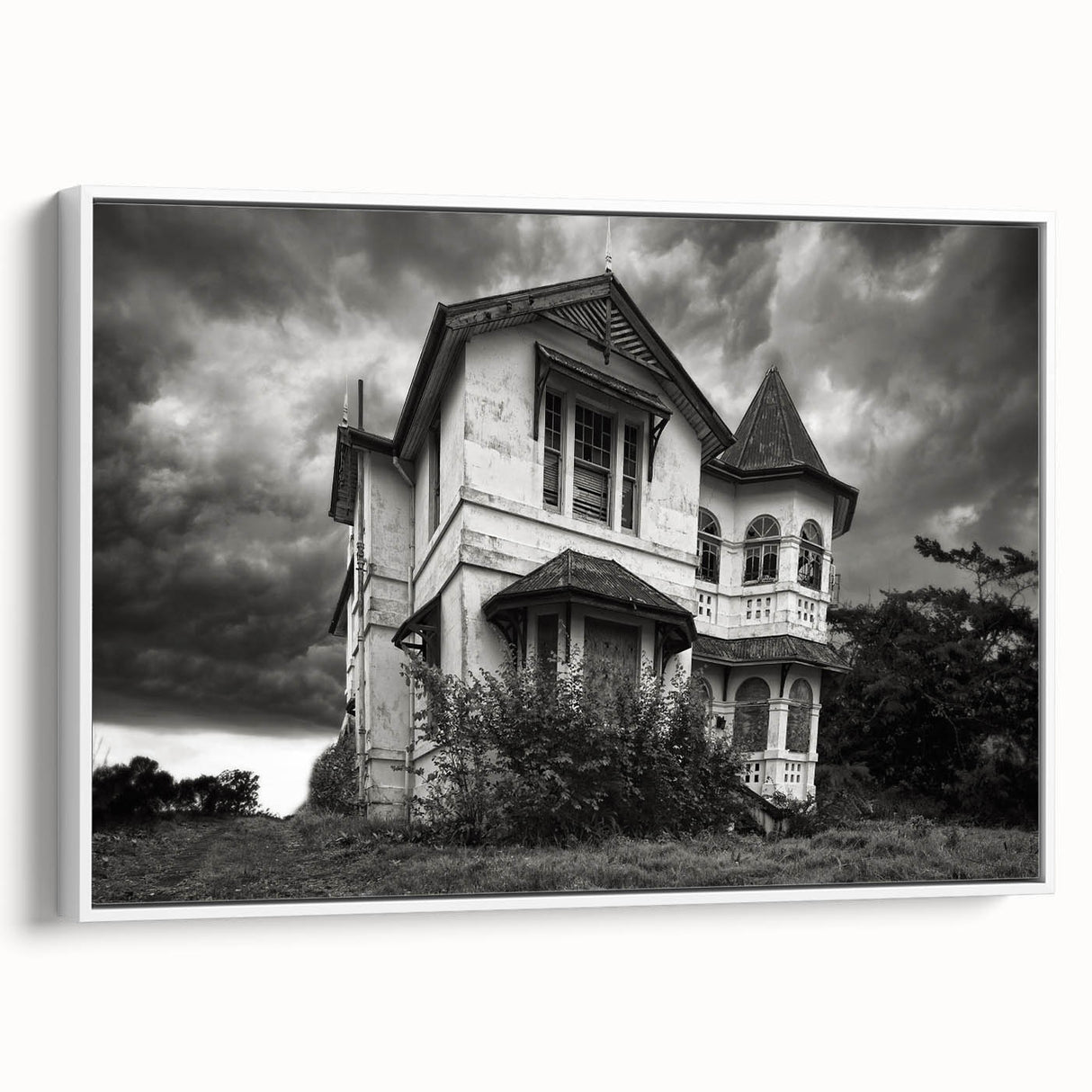 Vintage poster art of a dilapidated building in muted gray and black tones on a framed canvas, ideal for living room decor.