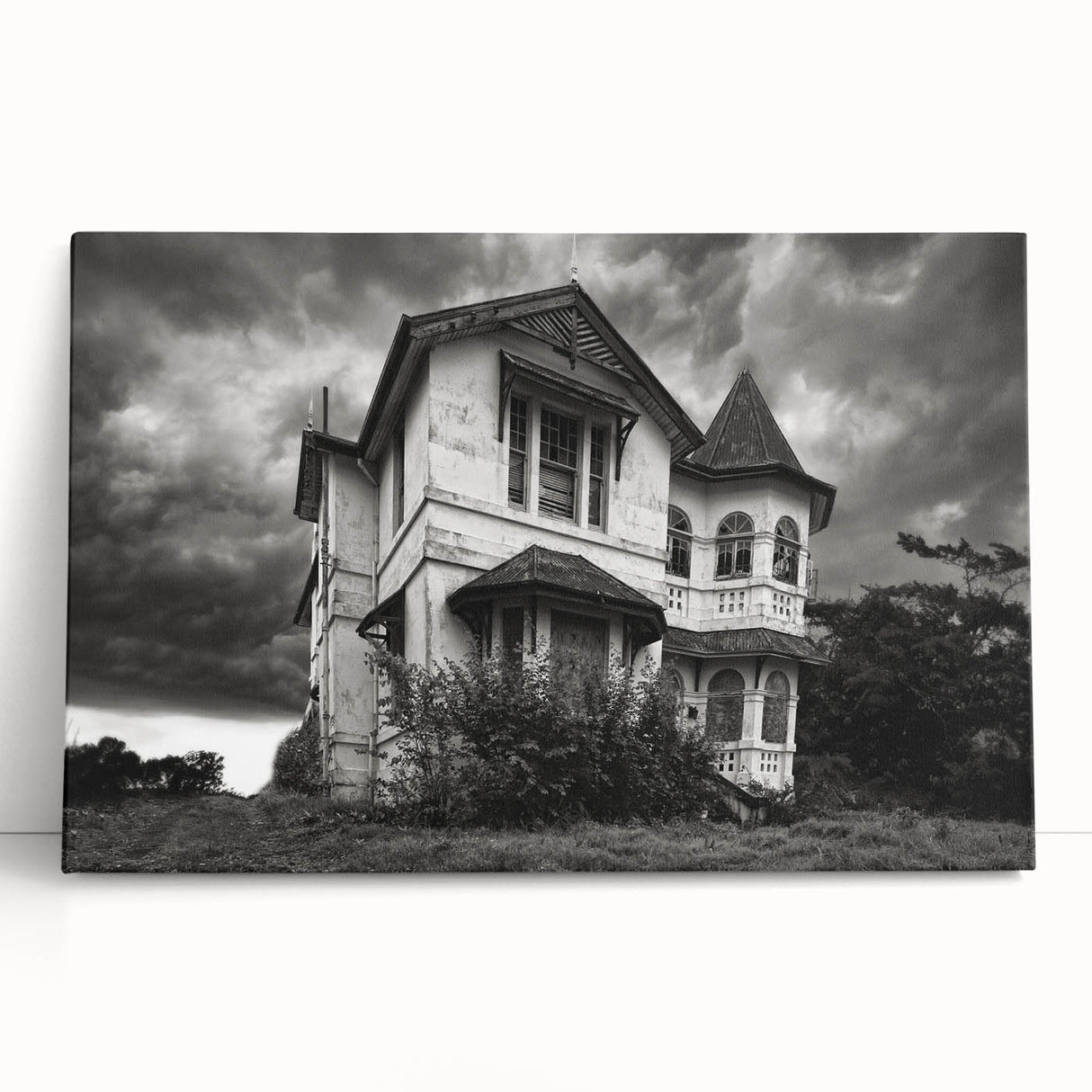 Black and white photograph of a dilapidated building on a large stretched canvas.