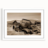 Abstract art print depicting a series of geometric shapes in muted gray and blue tones, framed with a white mat.