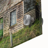 Large abstract wall art on acrylic glass featuring a close-up of architectural dereliction in muted gray tones.