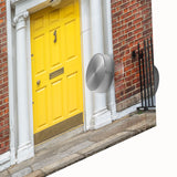 Close-up of a large abstract wall art on acrylic glass featuring geometric patterns in muted grays and whites.