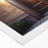 Art deco poster featuring a geometric door design in muted gold and black tones on rolled canvas.