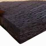 Close-up of a large art piece depicting a black and white landscape painting on stretched canvas.