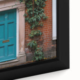 Close-up of a black wall art featuring a colorful, textured door design on a framed canvas, ideal for living room decor.