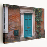 Side view of a large stretched canvas featuring a detailed architectural door design in neutral tones.