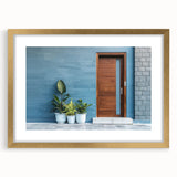 Textured abstract art print of a geometric door design in gold and white tones, framed with a mat.