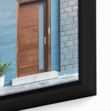 Close-up of a black framed canvas featuring a colorful, textured door design, ideal for living room decor.