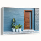 Framed canvas featuring a vintage poster art style landscape painting with muted black and gray tones.