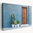 Side view of a large stretched canvas featuring a detailed architectural door design in neutral tones.