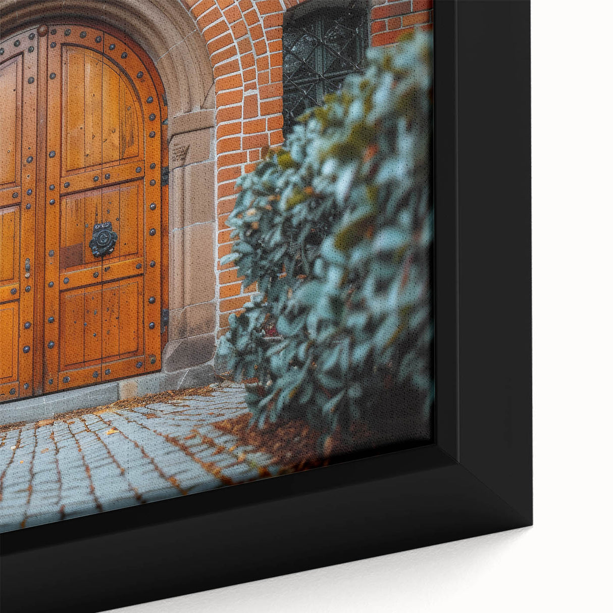 Close-up of black wall art featuring a textured, colorful door design on a framed canvas.