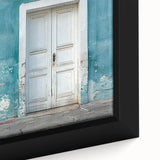 Framed canvas depicting a vintage poster of a colorful landscape with prominent black architectural elements.