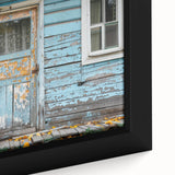 Close-up of a black framed canvas featuring a colorful, textured door design, ideal for living room decor.